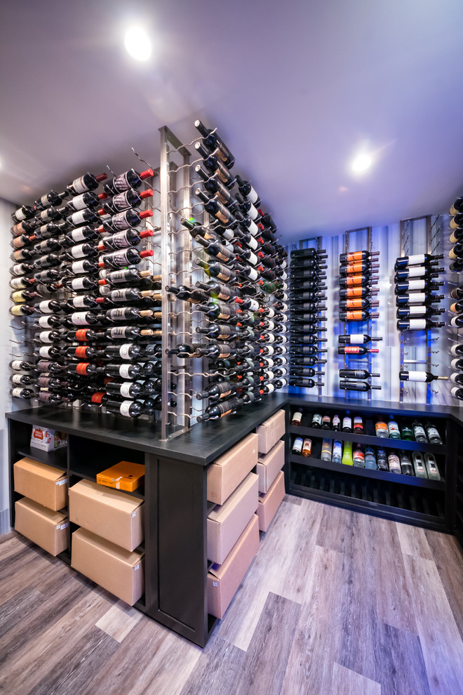 Inspiration for a large modern wine cellar in New York with porcelain flooring, display racks and grey floors.