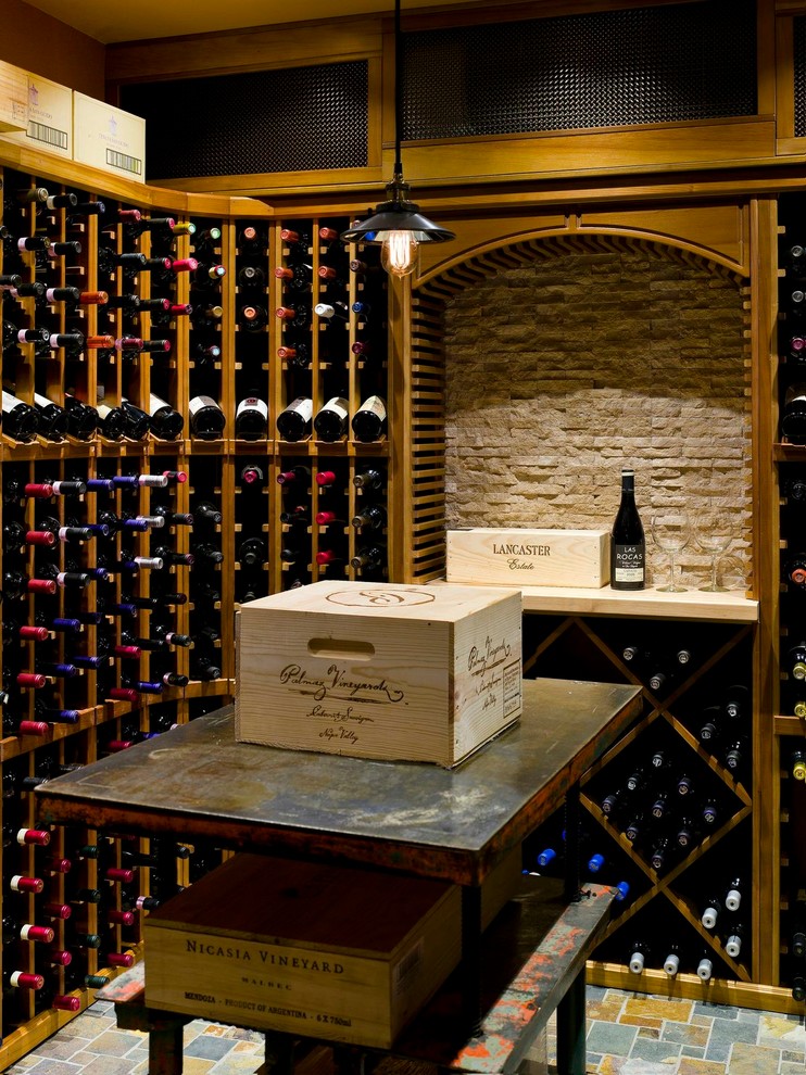 Photo of a rustic wine cellar in New York with storage racks.
