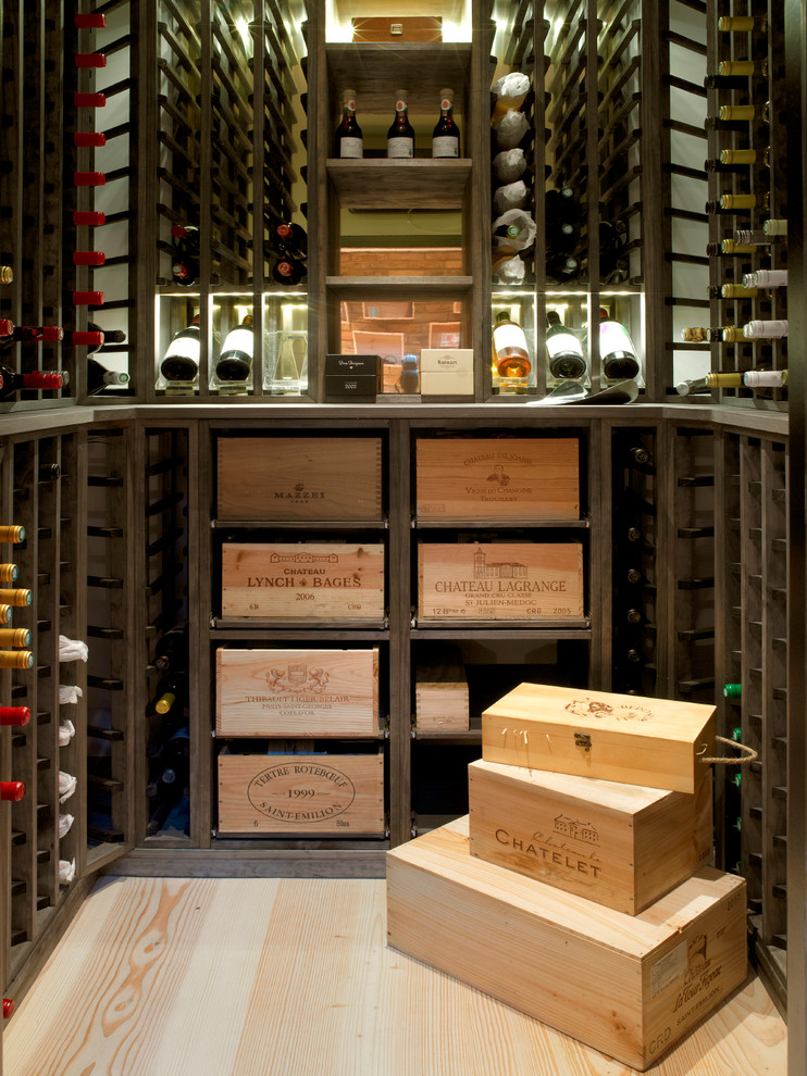 Design ideas for a small traditional wine cellar in London with light hardwood flooring, storage racks and beige floors.
