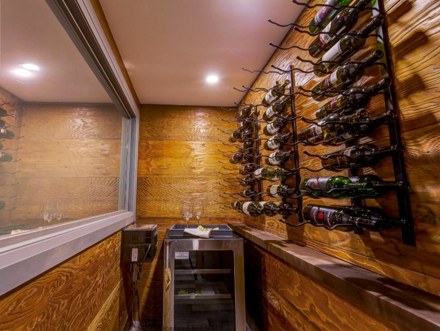 Example of a small mountain style wine cellar design in Toronto with storage racks