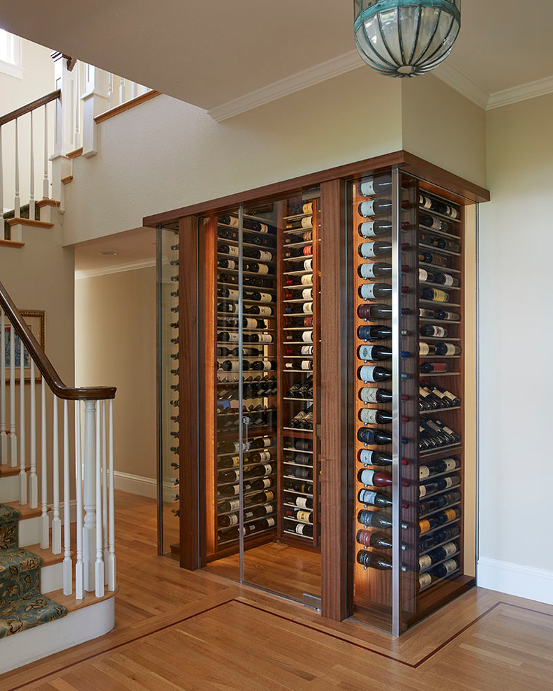 Wine cellar - transitional medium tone wood floor wine cellar idea in San Francisco with storage racks