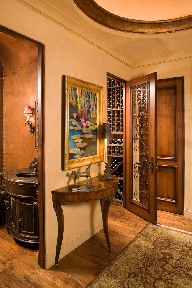 Wine cellar - mid-sized mediterranean medium tone wood floor and orange floor wine cellar idea in Minneapolis with storage racks