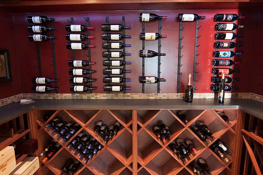 Wine cellar - mid-sized contemporary travertine floor wine cellar idea in Miami with diamond bins