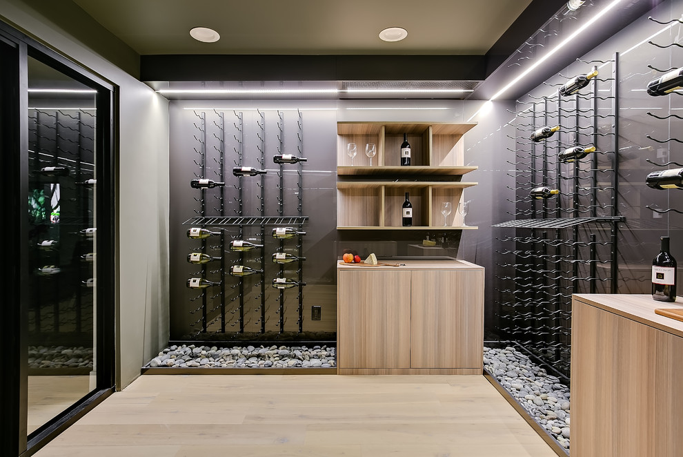 Inspiration for a mid-sized contemporary light wood floor and beige floor wine cellar remodel in Los Angeles with storage racks