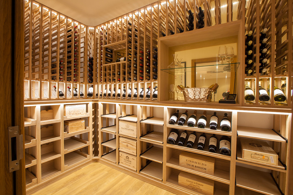 This is an example of a contemporary wine cellar in Essex with storage racks.
