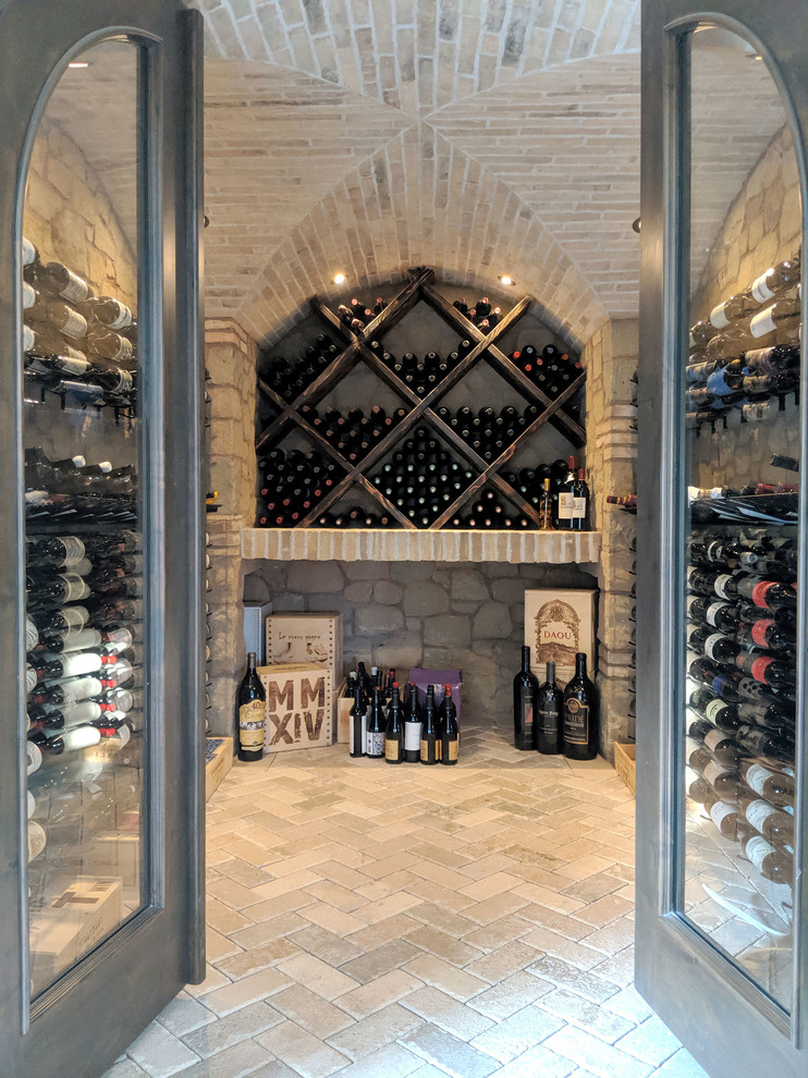 Inspiration for a small mediterranean wine cellar in San Francisco with cube storage and beige floors.