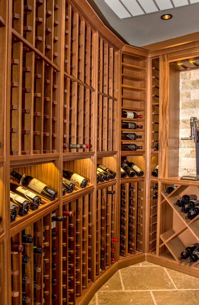 Example of a small tuscan yellow floor wine cellar design in Denver with storage racks