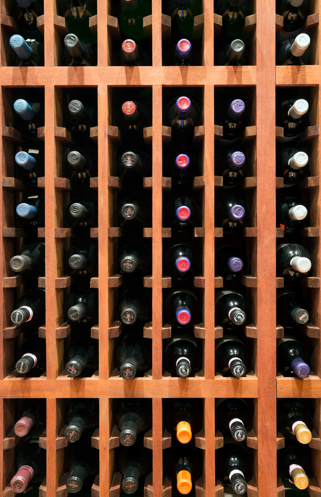 Inspiration for a large timeless light wood floor wine cellar remodel in New York with storage racks