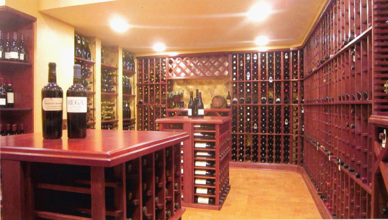 Inspiration for a large traditional wine cellar in Columbus with cork flooring and cube storage.