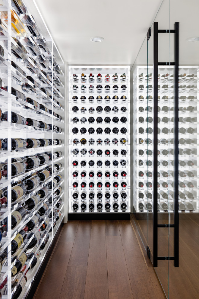 Wine cellar - small modern light wood floor and brown floor wine cellar idea in Seattle with storage racks