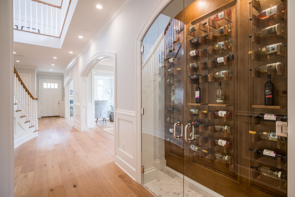Small transitional marble floor and white floor wine cellar photo in Los Angeles with display racks