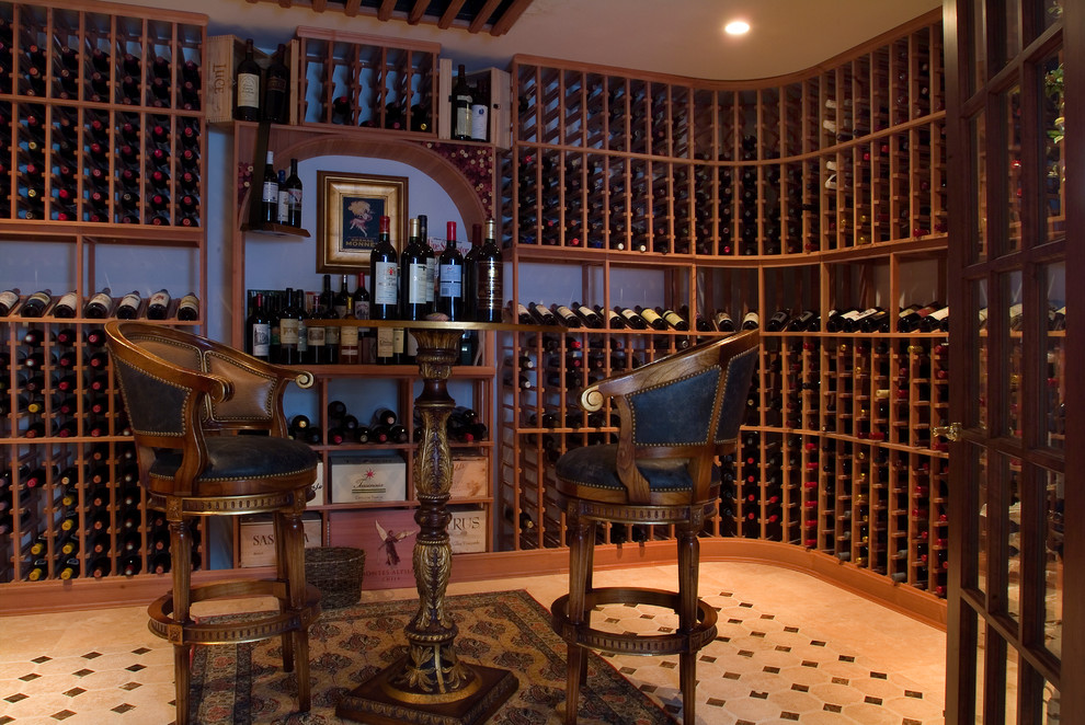 Huge elegant medium tone wood floor wine cellar photo in Philadelphia with storage racks