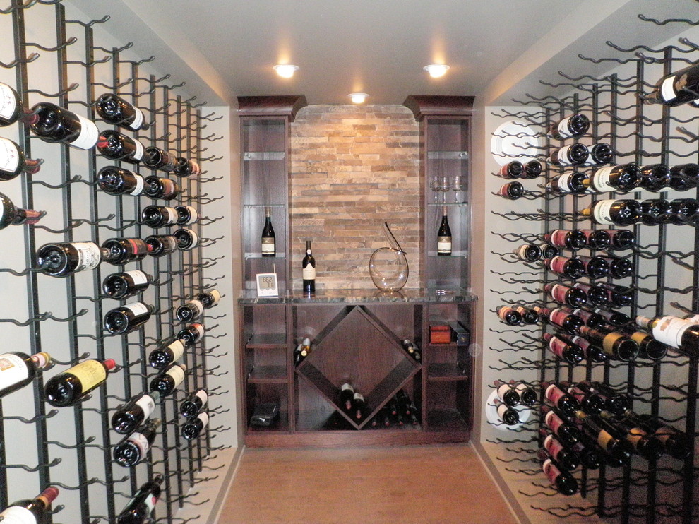 Wine cellar - mid-sized traditional cork floor wine cellar idea in Toronto with diamond bins