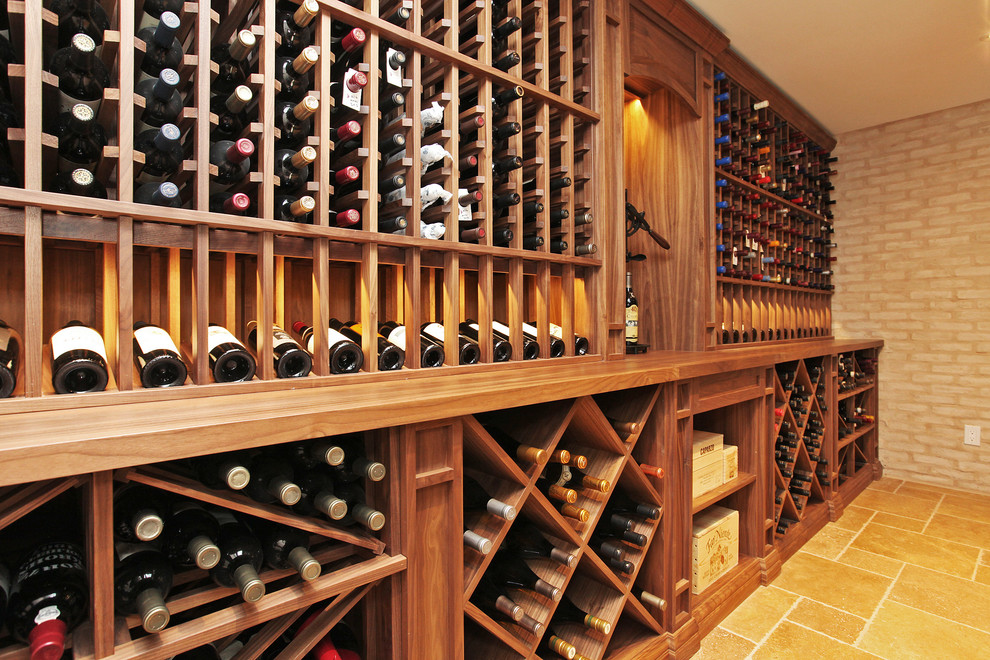 Inspiration for a large traditional wine cellar in Toronto with cube storage, travertine flooring and beige floors.