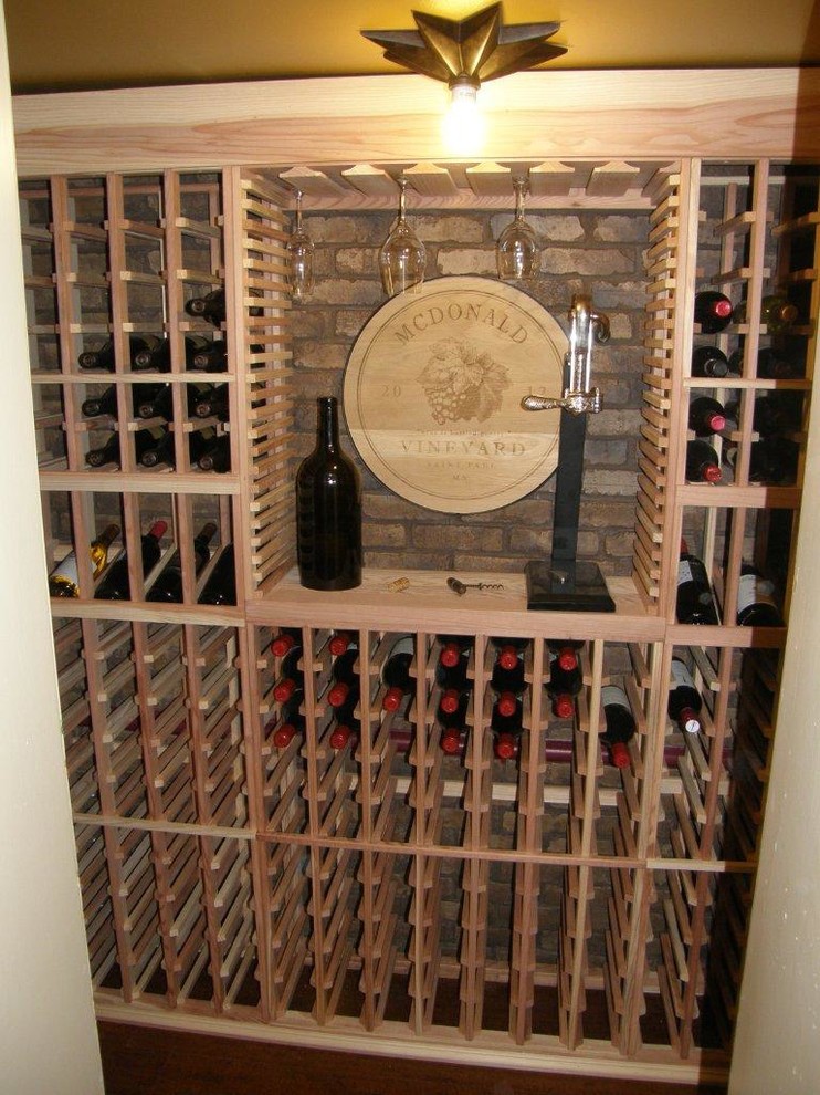 Example of a large classic dark wood floor and brown floor wine cellar design in Minneapolis with storage racks