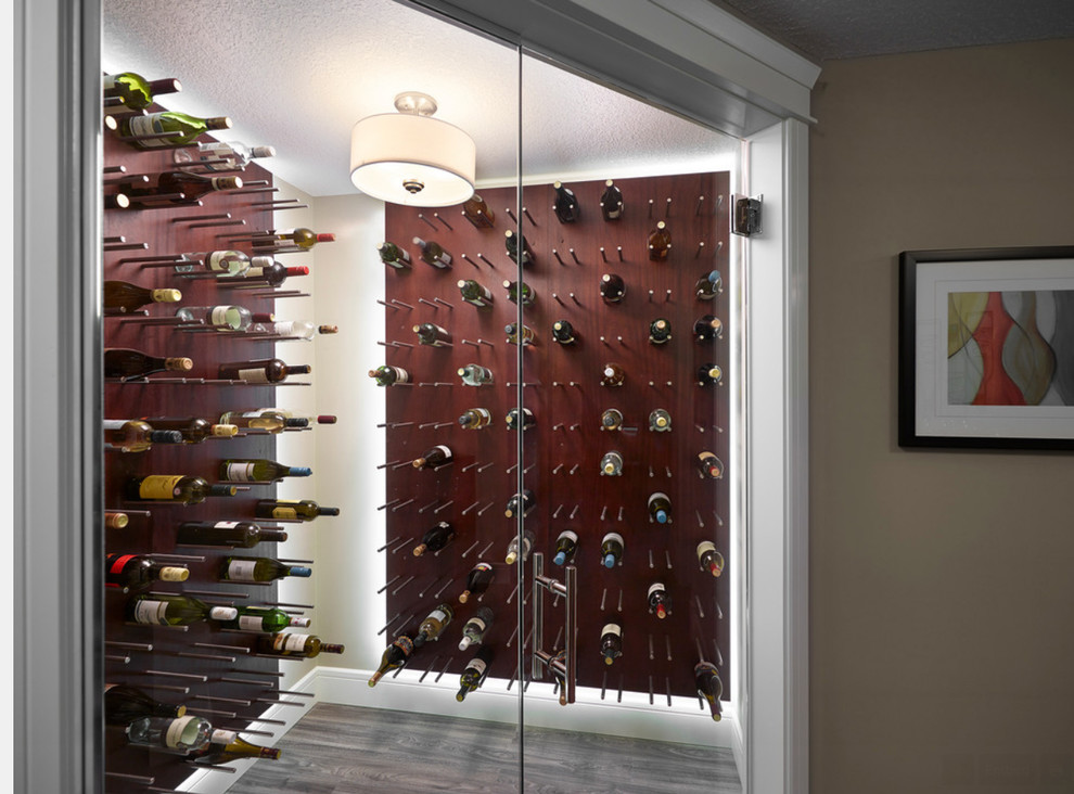 Example of a mid-sized trendy medium tone wood floor wine cellar design in Edmonton with display racks