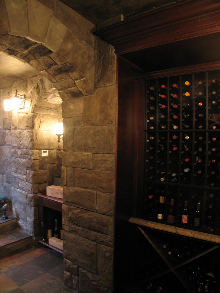 Example of a mid-sized tuscan slate floor wine cellar design in Seattle with storage racks