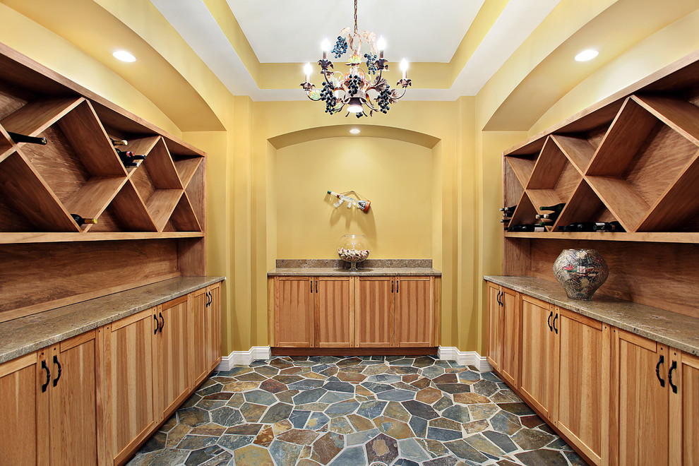 Medium sized world-inspired wine cellar in New York with ceramic flooring, display racks and green floors.