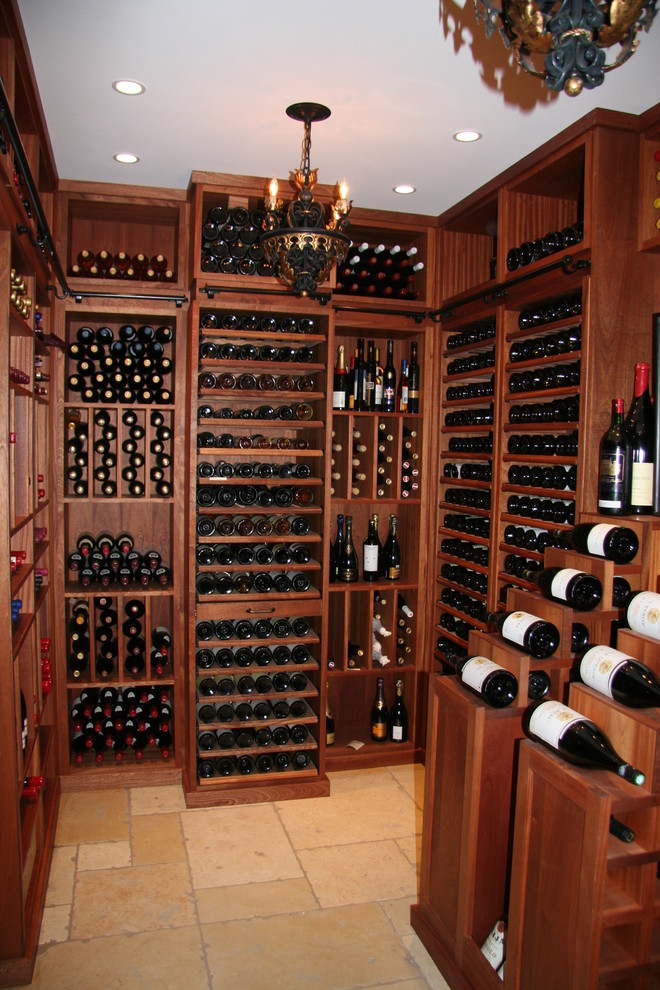 Large elegant travertine floor wine cellar photo in Philadelphia with display racks