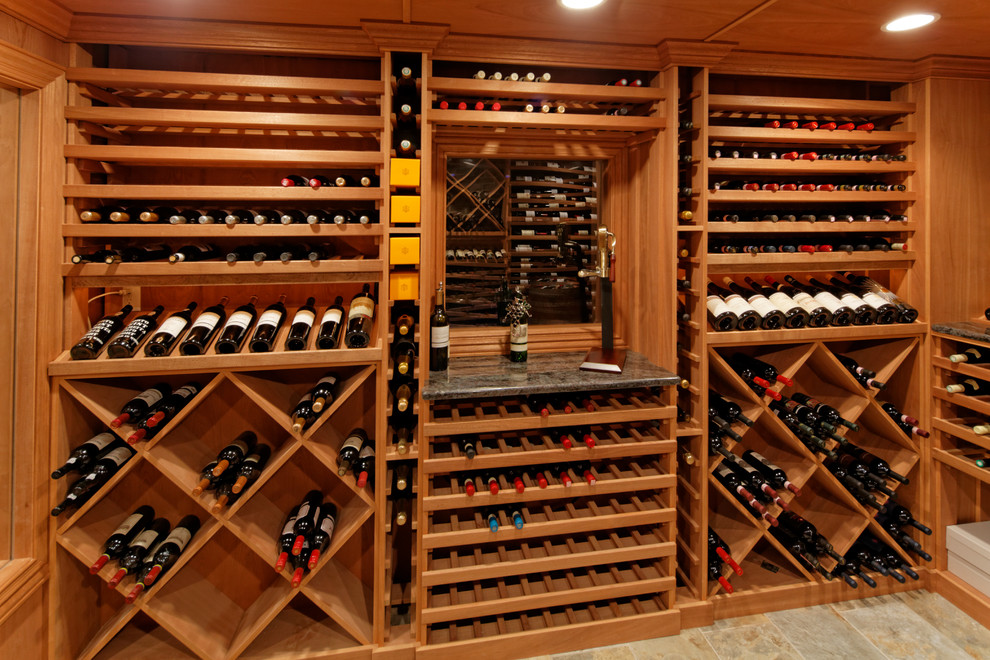 Inspiration for a large transitional ceramic tile wine cellar remodel in New York with display racks