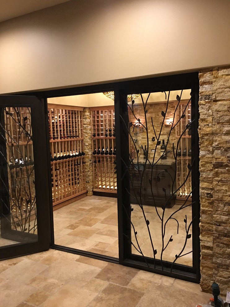 Expansive contemporary wine cellar in Phoenix with limestone flooring and storage racks.