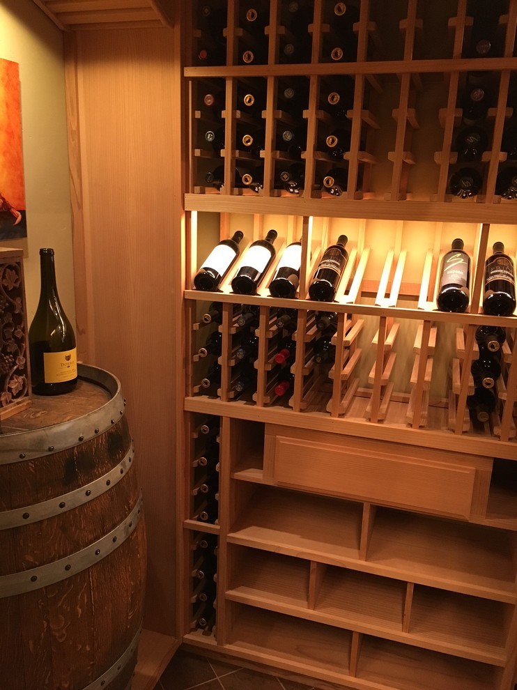 Photo of a medium sized classic wine cellar in San Diego with storage racks.
