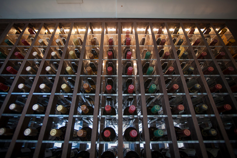 Inspiration for a wine cellar in London with display racks.