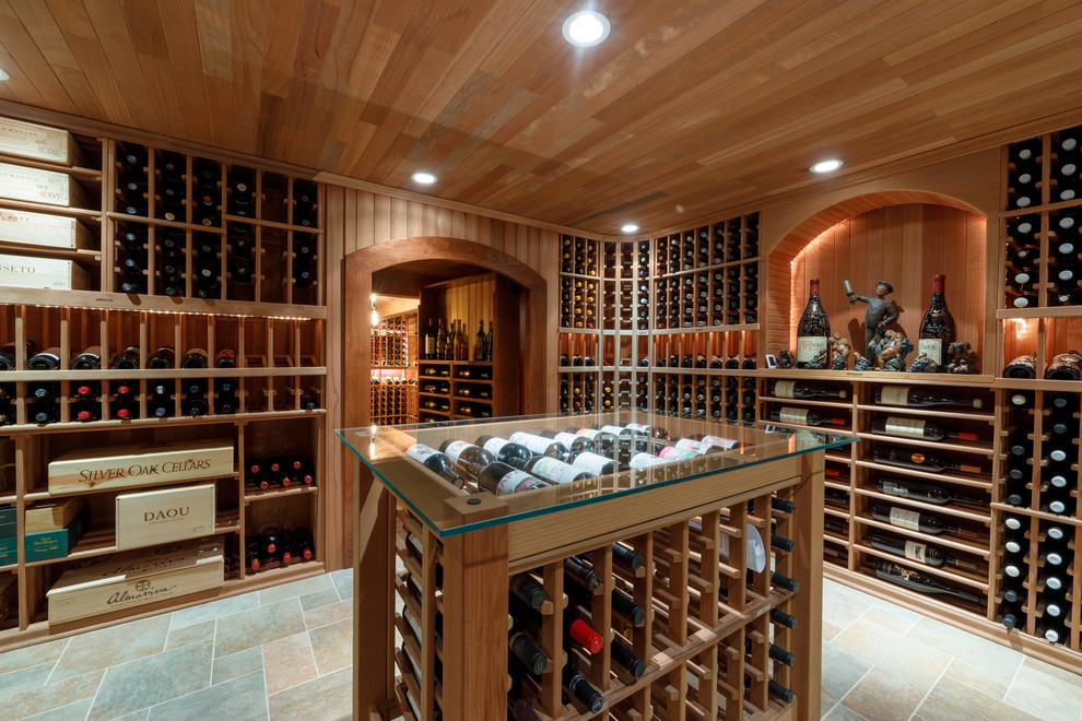 Large elegant porcelain tile and multicolored floor wine cellar photo in Other with storage racks