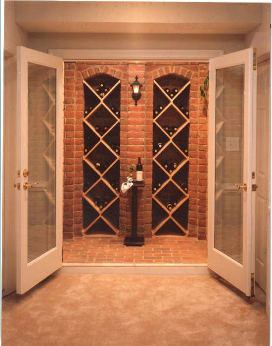Inspiration for a large traditional wine cellar in DC Metro with brick flooring and cube storage.