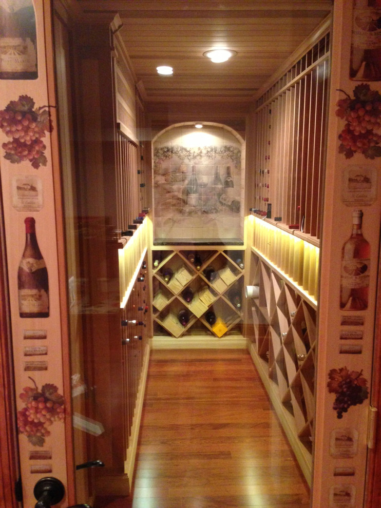 Photo of a medium sized traditional wine cellar in Philadelphia with medium hardwood flooring, storage racks and brown floors.