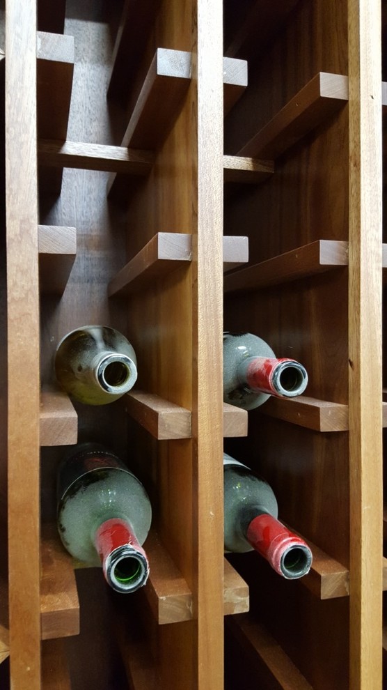Inspiration for a medium sized classic wine cellar in Other with storage racks.