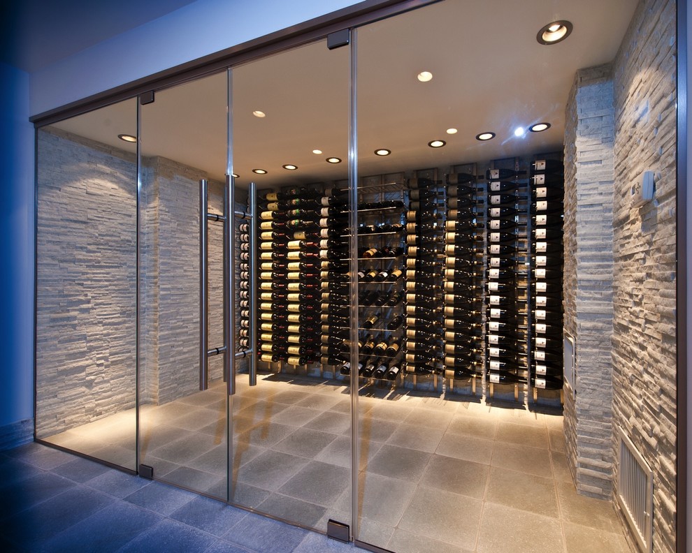 This is an example of a large contemporary wine cellar in New York with display racks.