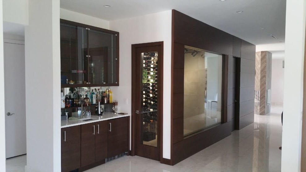 This is an example of a large contemporary wine cellar in Miami with marble flooring, display racks and white floors.