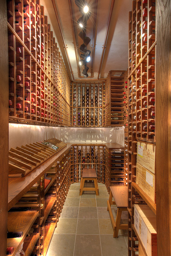 Inspiration for an expansive rustic wine cellar in New York with slate flooring and display racks.