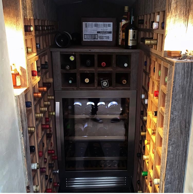 Exemple d'une petite cave à vin tendance avec parquet foncé, des casiers et un sol marron.