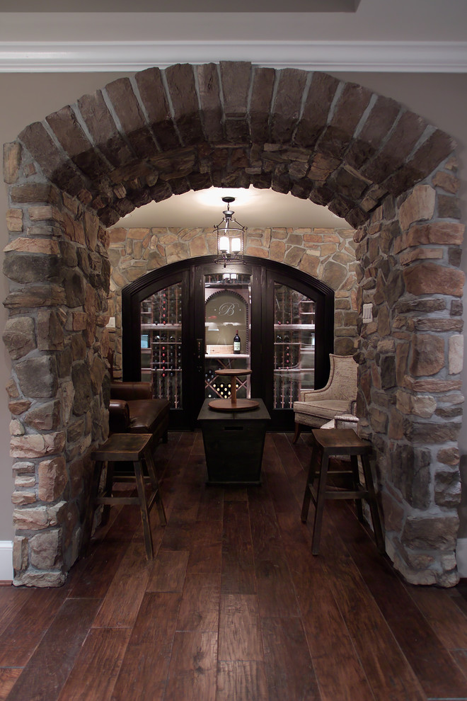 This is an example of a traditional wine cellar in DC Metro with brown floors.