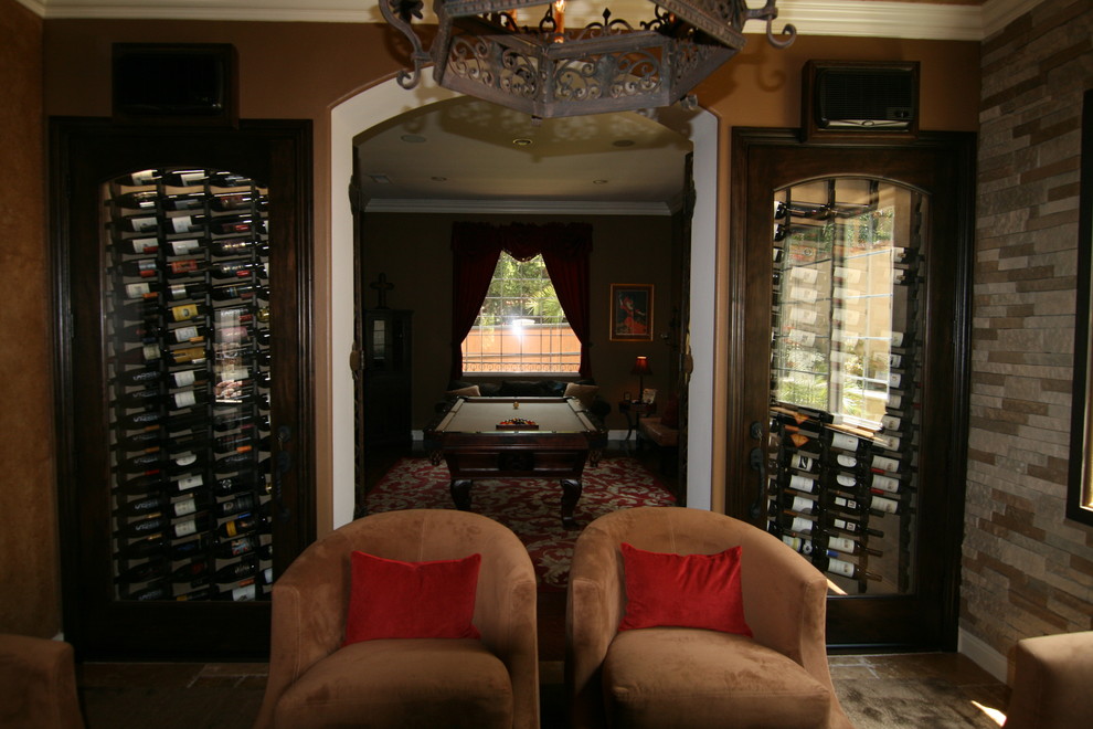 Mid-sized trendy slate floor wine cellar photo in Los Angeles with storage racks