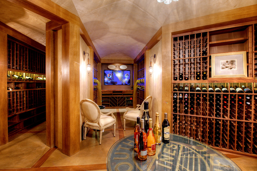 Large tuscan travertine floor wine cellar photo in San Francisco with display racks