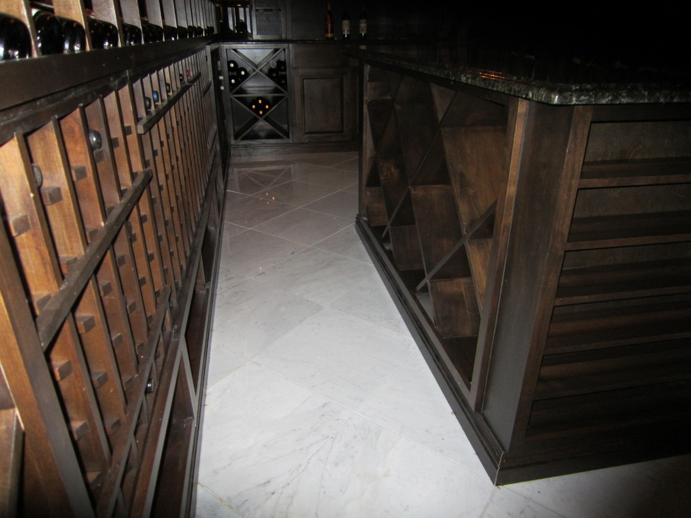 Mid-sized elegant marble floor wine cellar photo in New Orleans with storage racks