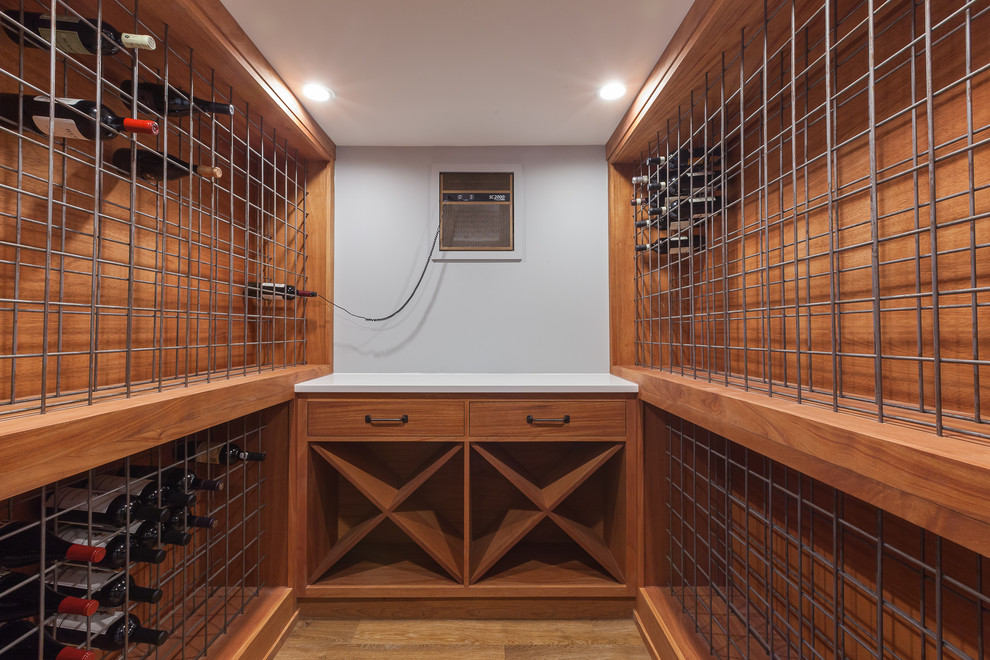 Design ideas for a medium sized industrial wine cellar in Chicago with laminate floors, storage racks and brown floors.