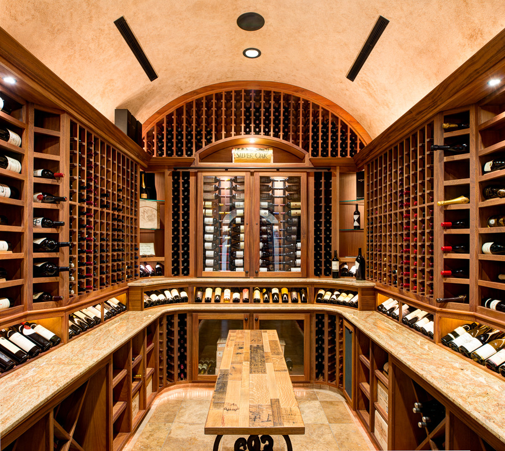 Wine cellar - large traditional marble floor wine cellar idea in Austin with display racks