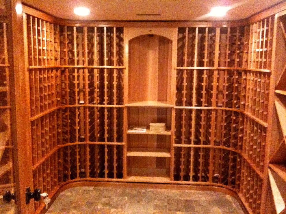 Inspiration for a mid-sized contemporary ceramic tile wine cellar remodel in Other with storage racks
