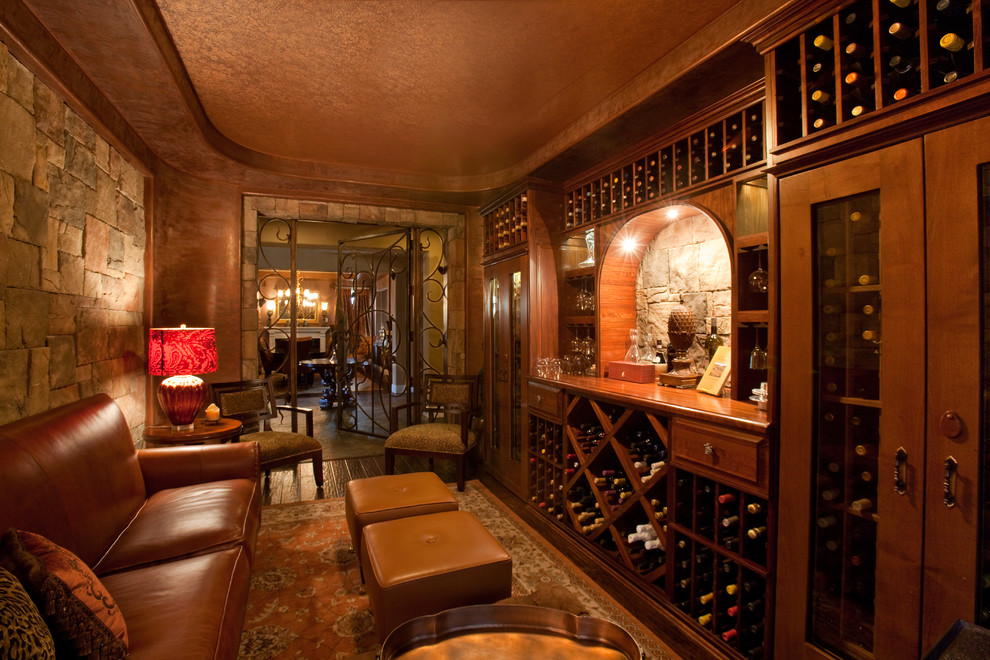 This is an example of a classic wine cellar in Las Vegas with dark hardwood flooring and storage racks.