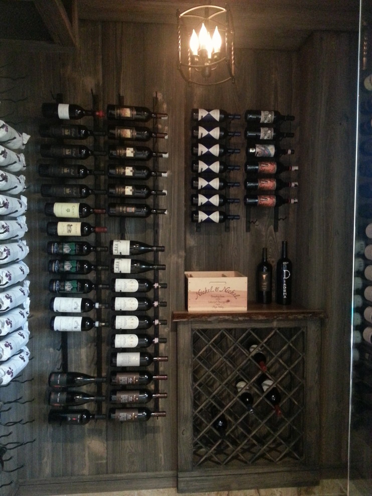 Small elegant marble floor wine cellar photo in Miami with storage racks