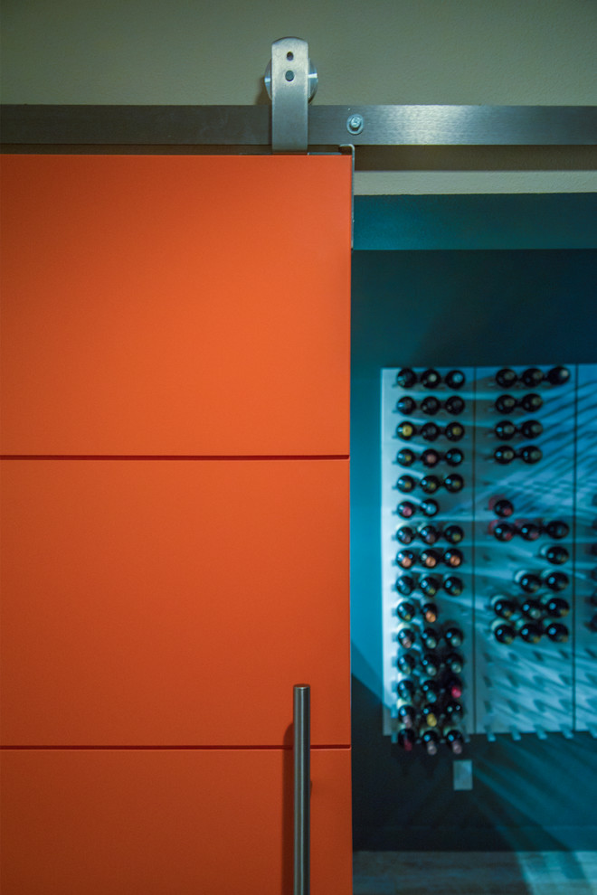 This is an example of a medium sized contemporary wine cellar in Seattle with storage racks.