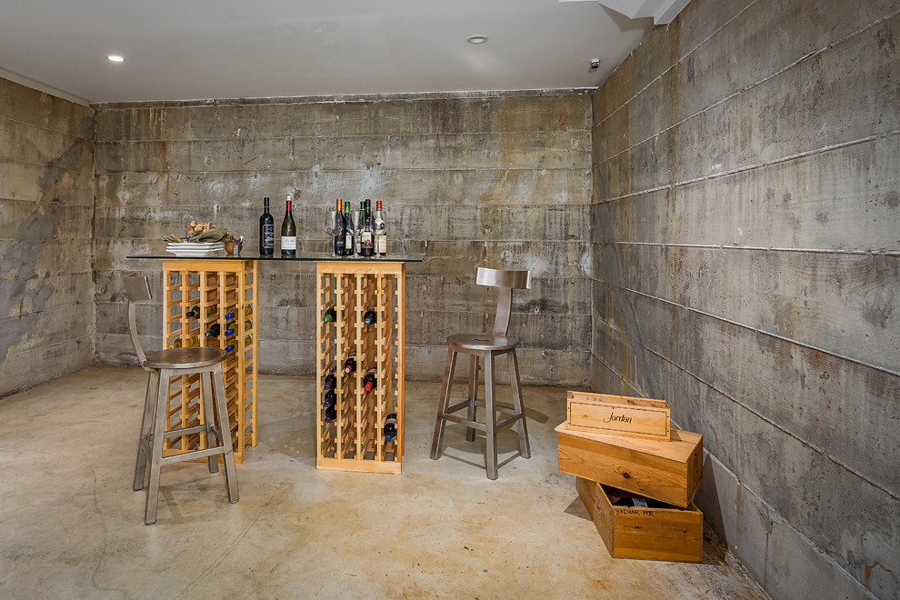 Идея дизайна: винный погреб среднего размера в стиле лофт с бетонным полом, стеллажами и серым полом