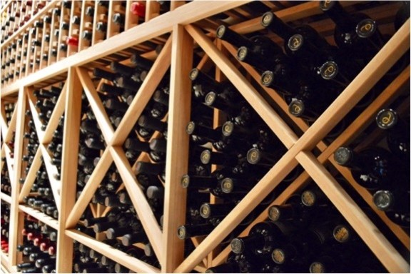 Wine cellar - mid-sized traditional wine cellar idea in Other with storage racks