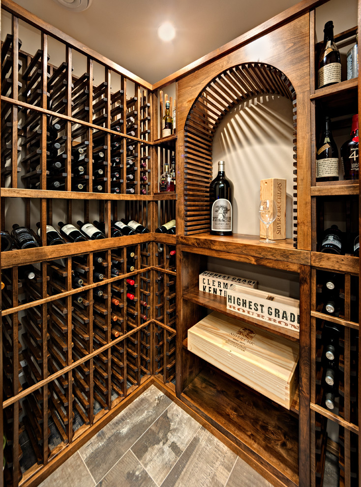 Large mountain style porcelain tile and gray floor wine cellar photo in Minneapolis with storage racks