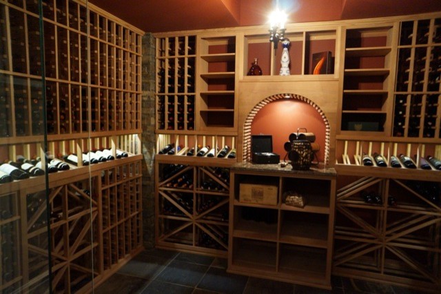 Medium sized contemporary wine cellar in Toronto with slate flooring, storage racks and grey floors.