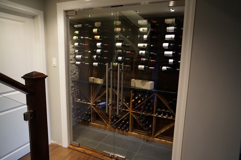 Photo of a medium sized contemporary wine cellar in Toronto with grey floors, ceramic flooring and storage racks.